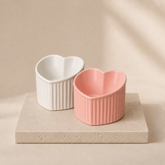 Mira tilted ceramic cat bowl with a ribbed base on travertine