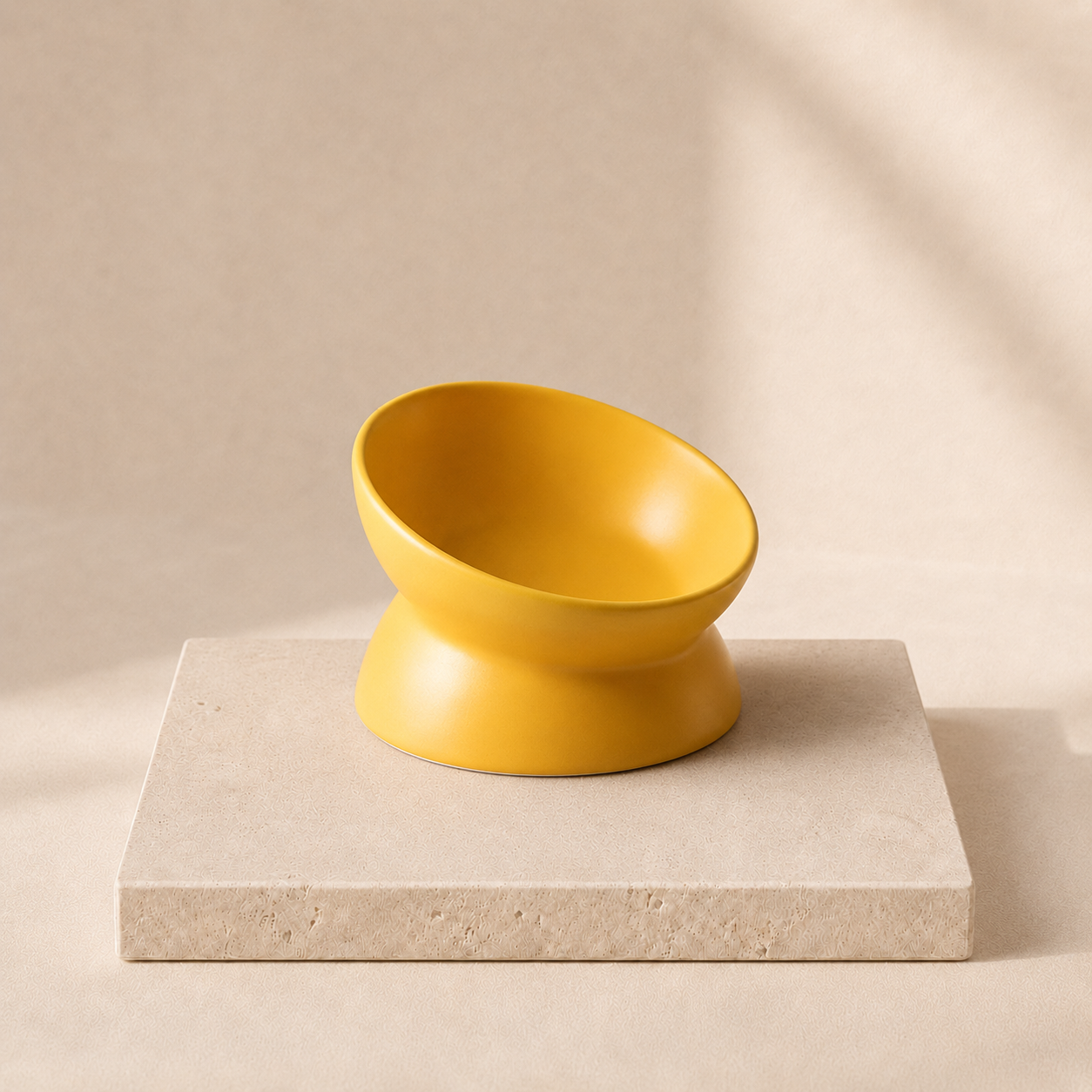 Lumi yellow tilted ceramic pet bowl on cream travertine pedestal
